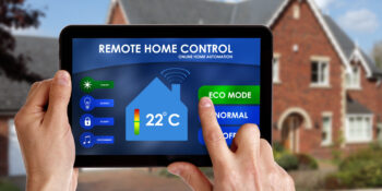 Remote home control Holding a smart energy controller or remote home control online home automation system on a digital tablet. All screen graphics made up.